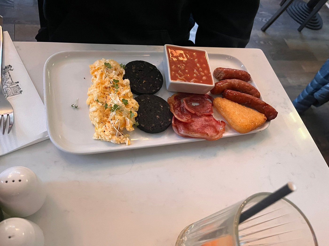 Breakfast with sausages, poached eggs, mushrooms, grilled tomato, and hash brown without toast.